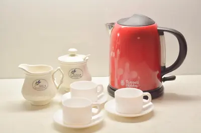 a red tea kettle and cups on a table at Central and modern in Belgrade