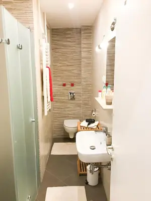 a bathroom with a white sink and a toilet at Central and modern in Belgrade