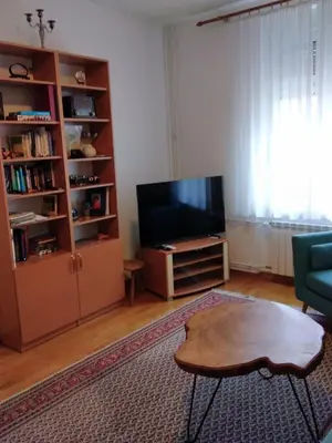 a living room with a tv and a coffee table at Central and modern in Belgrade