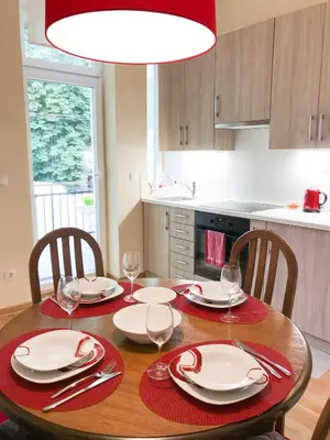 a dining room table with plates and wine glasses at Central and modern in Belgrade