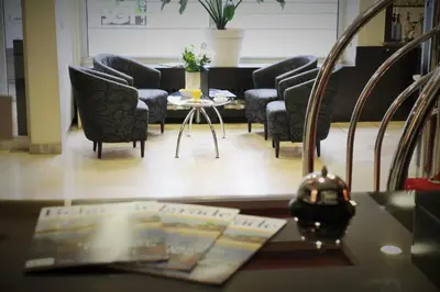 a living room with couches and a coffee table at Hotel Rex in Belgrade