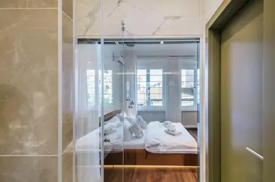 a room with a bed and a glass shower at Room 25 Belgrade in Belgrade