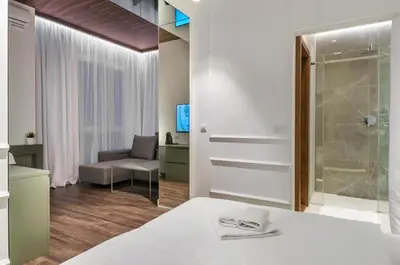 a bedroom with a bed and a glass shower at Room 25 Belgrade in Belgrade