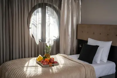 a tray of fruit sitting on top of a bed at Akacija Luxury Suites- Zemunski kej in Belgrade