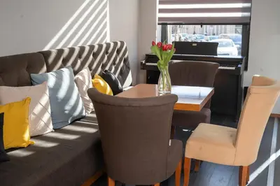 a living room with a couch and a table at Akacija Luxury Suites- Zemunski kej in Belgrade