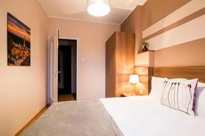 a bedroom with a large bed with white sheets at Apartments Top Central 3 in Belgrade