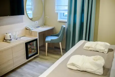 a hotel room with a bed and a mirror at Garni Hotel D10 in Belgrade