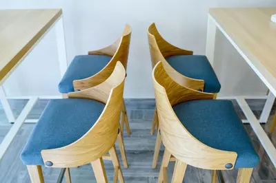 two chairs with blue seats at a table at Garni Hotel D10 in Belgrade