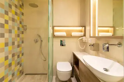 a bathroom with a toilet and a sink and a shower at Garni Hotel D10 in Belgrade