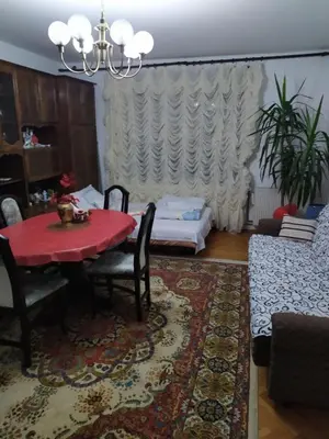 a living room with a red table and a couch at Apartment Ljupka in Pančevo