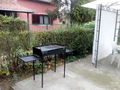 a black piano in front of a house at Apartment Ljupka in Pančevo