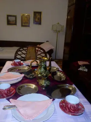 a table with plates and dishes on a table at Apartment Ljupka in Pančevo