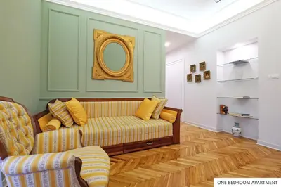 a living room with a couch and a mirror at Downtown Belgrade Apartments in Belgrade