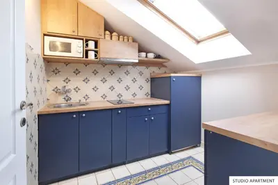a kitchen with blue cabinets and a sink at Downtown Belgrade Apartments in Belgrade