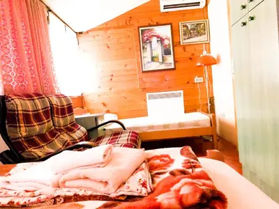 a room with a bed and a couch and a table at Vila Aleksandar in Smederevo