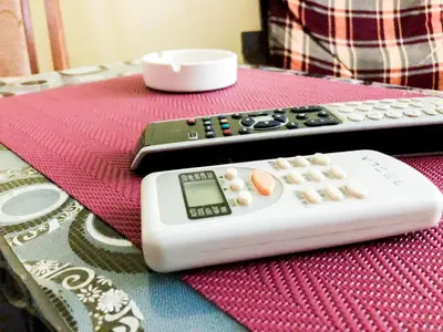 two remote controls sitting on top of a table at Vila Aleksandar in Smederevo