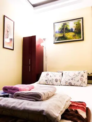 a bedroom with a bed with towels on it at Vila Aleksandar in Smederevo