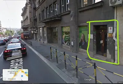 a city street with a car parked on the street at Habitat Hostel in Belgrade