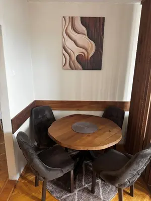 a table and chairs in a room with a painting at Apartment 36 in Belgrade