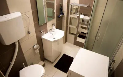 a small bathroom with a toilet and a sink at Apartment 36 in Belgrade