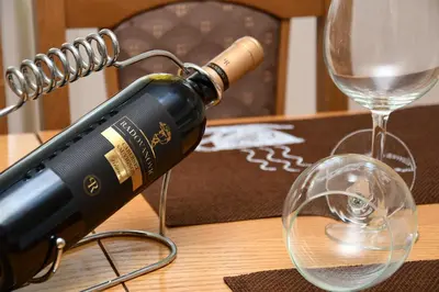 a bottle of wine sitting on a table next to a glass at Apartment 36 in Belgrade
