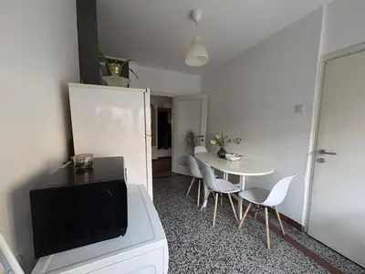 a living room with a white table and a tv at Star apartment in Belgrade