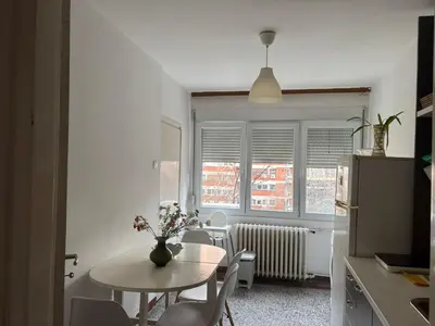 a kitchen with a table and a table and chairs at Star apartment in Belgrade