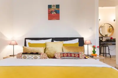a bedroom with a large bed with yellow pillows at City Side Up Exclusive in Belgrade