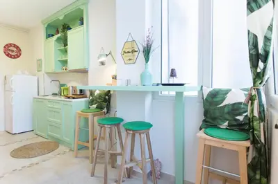 a kitchen with a counter and stools in a room at City Side Up Exclusive in Belgrade