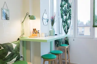 a room with a desk and stools in a room at City Side Up Exclusive in Belgrade