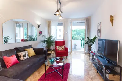 a living room with a couch and a tv at City Side Up Exclusive in Belgrade