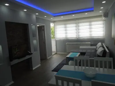 a living room with a couch and a tv at Danube Blue in Belgrade