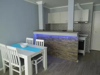 a kitchen with a table and chairs and a counter at Danube Blue in Belgrade
