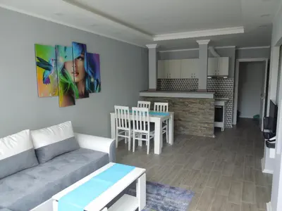 a living room with a couch and a kitchen at Danube Blue in Belgrade