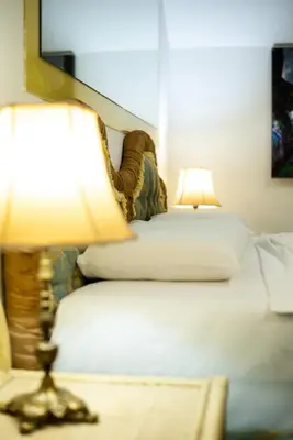 a bedroom with a bed with two lamps on it at Olympic Wellness & Spa Apartments in Belgrade