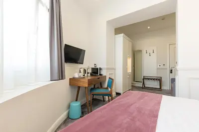 a hotel room with a desk and a tv at Public House Hotel in Belgrade