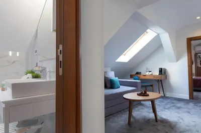 a living room with a couch and a table at Public House Hotel in Belgrade