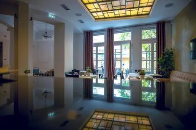 a large room with large windows and a hallway at Public House Hotel in Belgrade