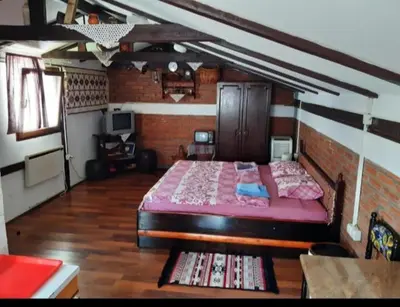 a bedroom with a large bed in a brick wall at Julijana in Belgrade