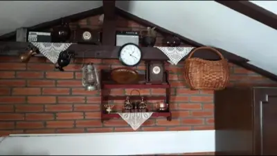 a brick wall with a clock and a basket at Julijana in Belgrade