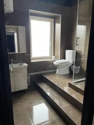 a bathroom with a toilet and a sink and a window at DND-X in Pančevo