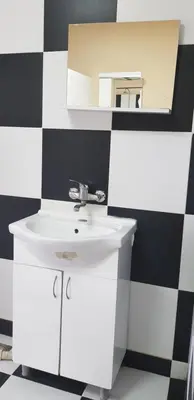 a bathroom with a white sink and a mirror at DND-X in Pančevo