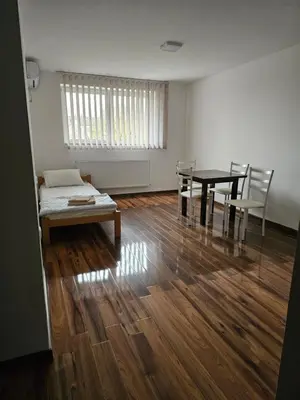 a room with a table and chairs and a bed at DND-X in Pančevo