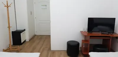 a living room with a tv and a desk with a computer at DND-X in Pančevo