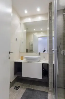 a bathroom with a sink and a mirror at Sava Smart Apartment in Belgrade