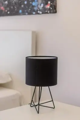 a black lamp sitting on a table in a room at Sava Smart Apartment in Belgrade