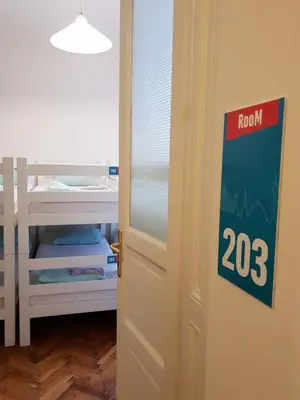 an open door with a room sign next to it at Booking BnB in Belgrade