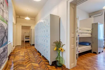 a room with two bunk beds and a vase with flowers at Booking BnB in Belgrade
