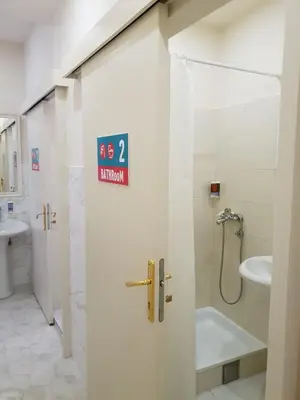 a bathroom with a shower and a toilet and a sink at Booking BnB in Belgrade