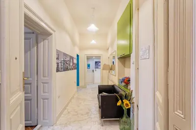 a hallway with a couch and flowers in a room at Booking BnB in Belgrade
